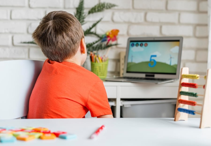 Kid watching video on laptop